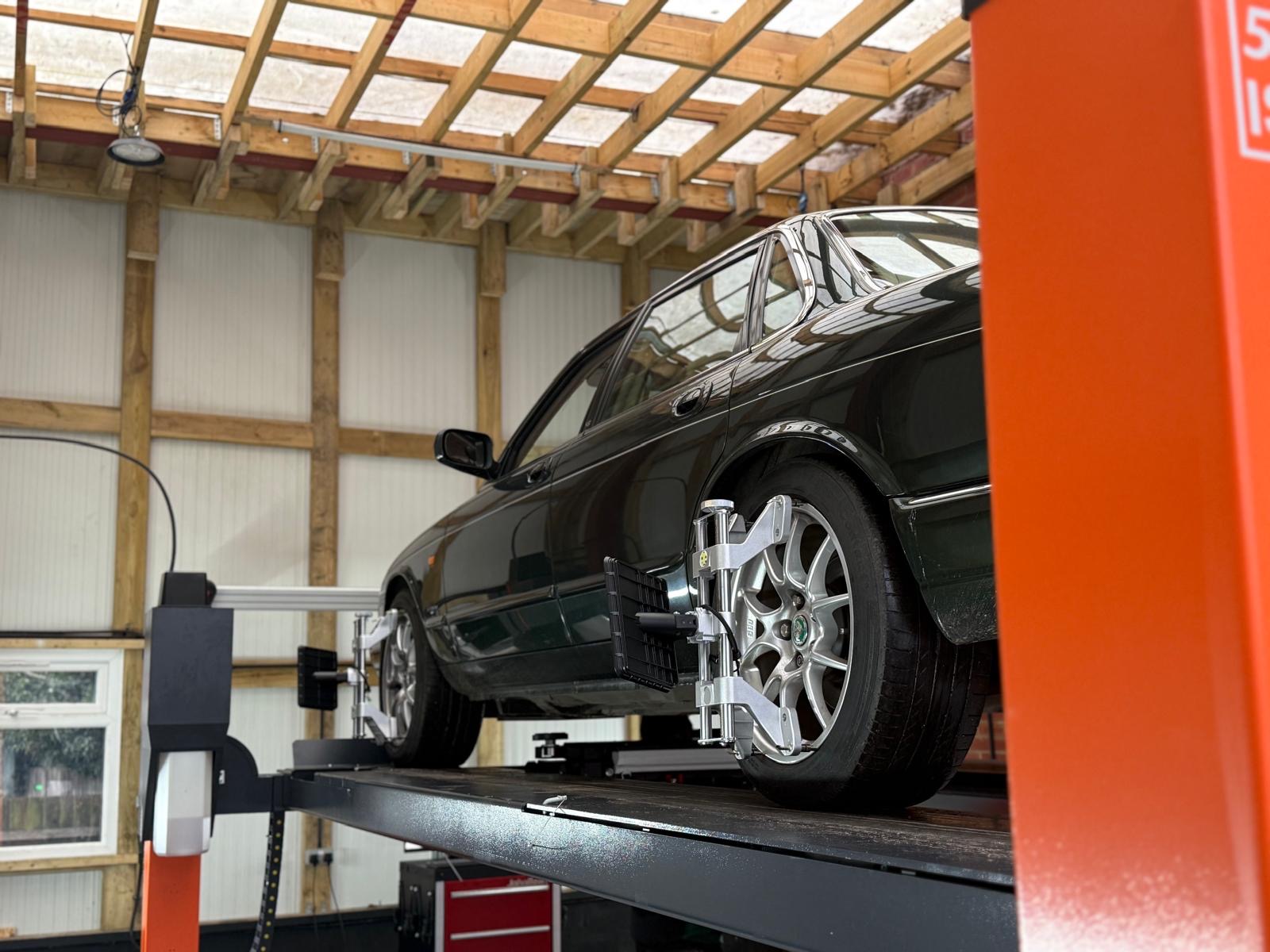 Car on ramp with laser alignment tool fitted